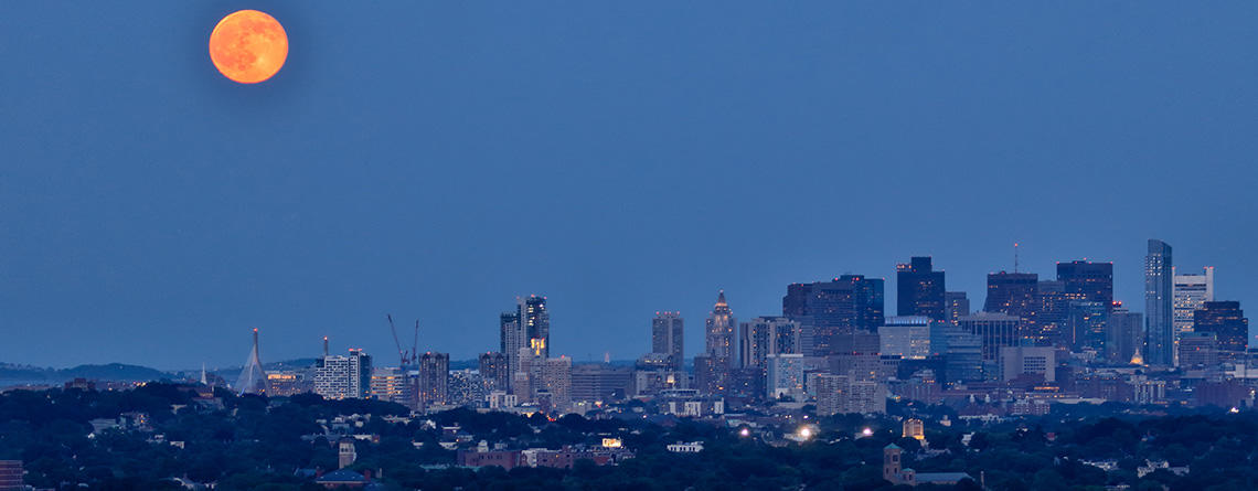 Boston skyline at night under a full moon © Ramkumar Subramanian