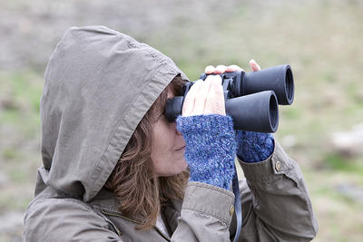 Woman w binoculars birding in winter © Nick DeCondio