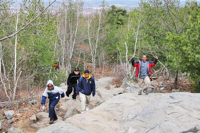 Boys hiking up boulder trail at Blue Hills Trailside Museum