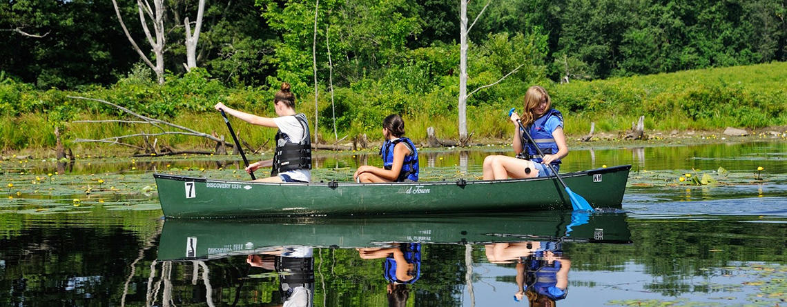 Teen girls canoeing at Wachusett Meadow Wildlife Sanctuary