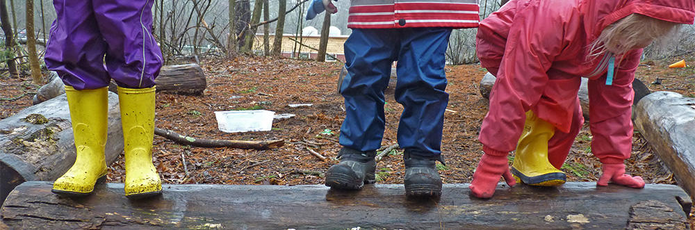 Preschoolers playing on a log