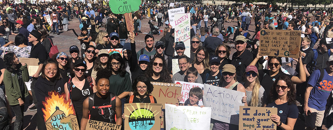 People at a Climate Strike holding signs