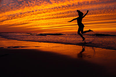 Girl on beach at sunset copyright May Adams 750