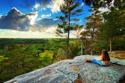 Girl sitting on a rock looking out at Moose Hill Wildlife Sanctuary copyright Arthur Fisher