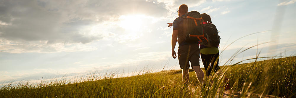 Couple hiking the boardwalk trail at Wellfleet Bay