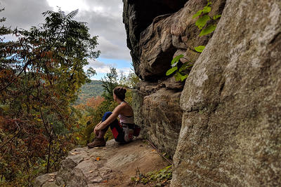 Rock climber taking in the view mid-climb © Arbenne Kelly