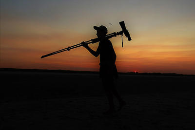 Young birder with scope silhouette at sunset © Andy Eckerson