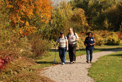 Three people walking on BNC's All Persons Trail