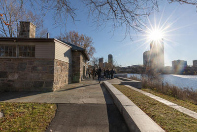 Landscape of Magazine Beach on the Charles River with solar flare