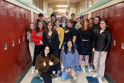 Teenagers standing inside a school hallway