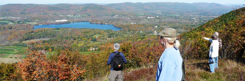 Adults hiking at Pleasant Valley Wildlife Sanctuary in autumn