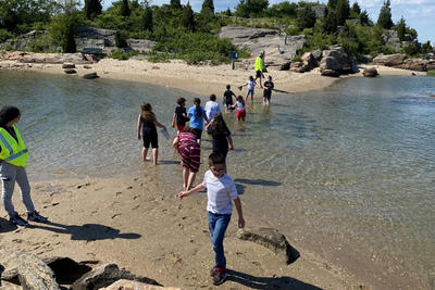 Children playing in a channel of water