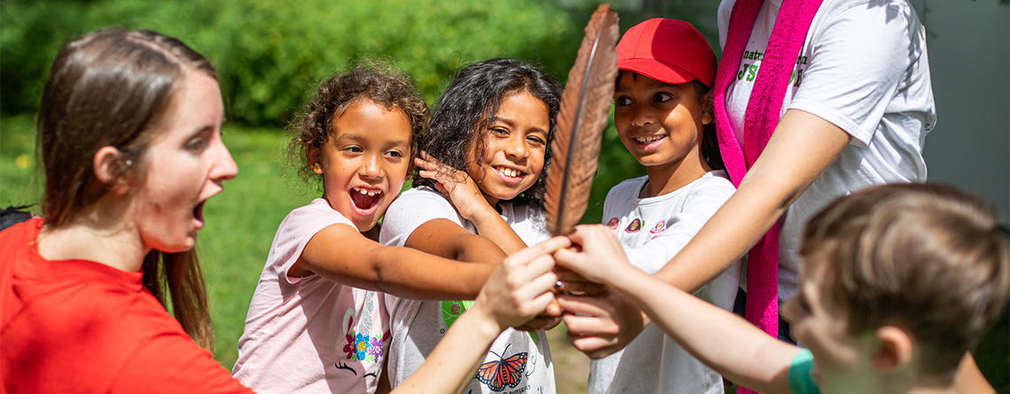 Arcadia campers holding a Wild Turkey feather