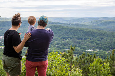 Parents & infant looking gazing out from an overlook at Arcadia Wildlife Sanctuary in spring © Phil Doyle
