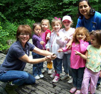 A group of kids with a naturalist at Broad Meadow Brook Wildlife Sanctuary