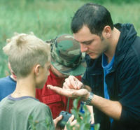 Naturalist showing kids an insect