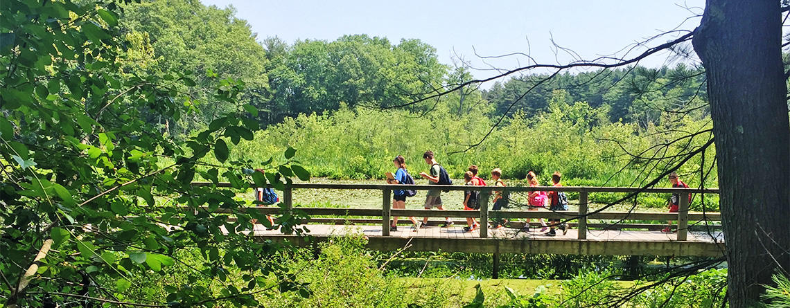 Broadmoor Discoverers campers crossing boardwalk
