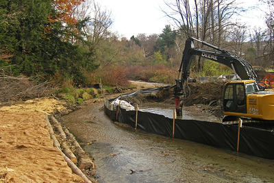 Excavator during dam removal on the Sackett Brook at Canoe Meadows Wildlife Sanctuary