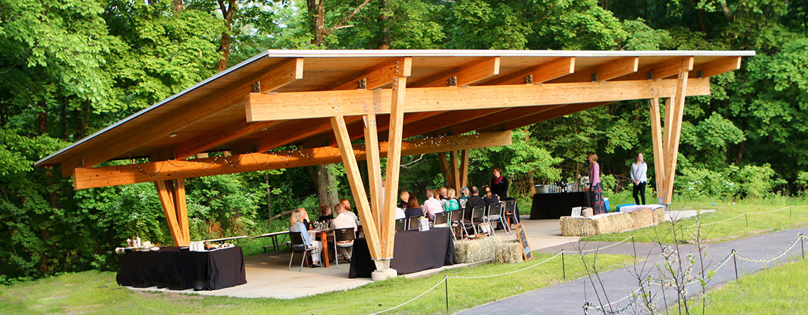 Gathering in the Bluebird Pavilion outdoor event space at Drumlin Farm Wildlife Sanctuary