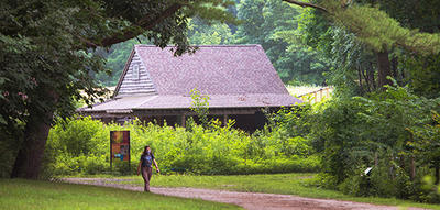 Person walking the farmyard loop trail at Drumlin Farm Wildlife Sanctuary © Gretchen Ertl