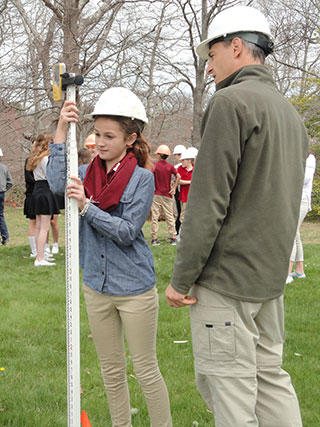 Ian Ives shows student how to measure the depth