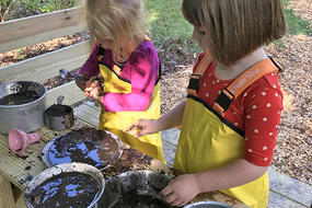 Long Pasture Nature Preschool Explorers making mud pies