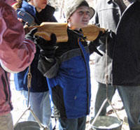 Boy carrying sap with a yoke