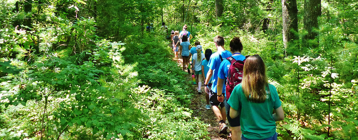 North River campers walking a wooded trail