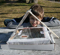 A boy makes a solar oven at Oak Knoll Wildlife Sanctuary
