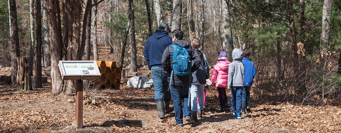 A school group walking the main trail in fall at Oak Knoll Wildlife Sanctuary