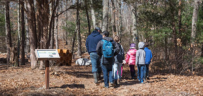 A school group walking the main trail in fall at Oak Knoll Wildlife Sanctuary