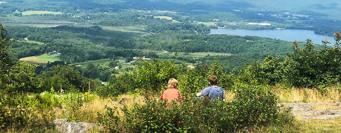 Two campers resting on a trail overlook at Pleasant Valley Wildlife Sanctuary