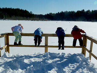 Kids looking out from overlook in winter