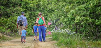 Family on a trail in summer at Tidmarsh Wildlife Sanctuary © Jeanne Lesperance
