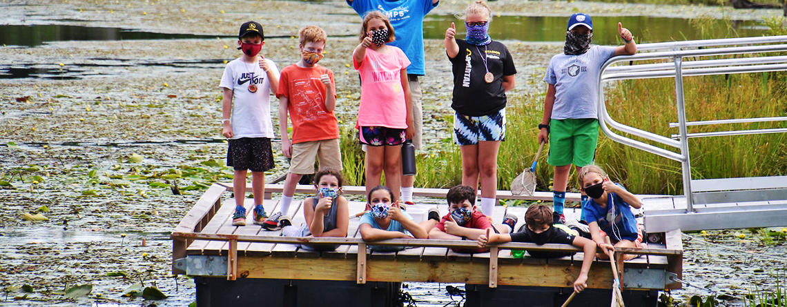 Adventurers campers on the pond dock at Wachusett Meadow Wildlife Sanctuary