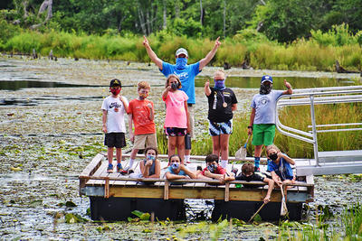 Adventurers campers on the pond dock at Wachusett Meadow Wildlife Sanctuary