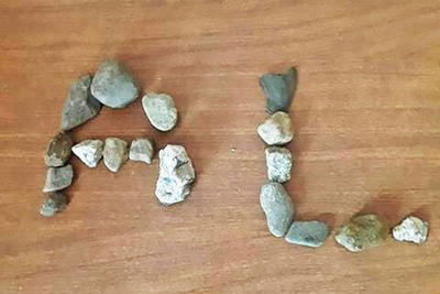 A Gardener Head Start student's project uses rocks to spell out their initials