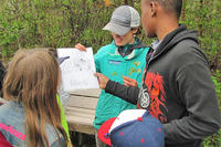 Wellfleet Bay educator showing students a map
