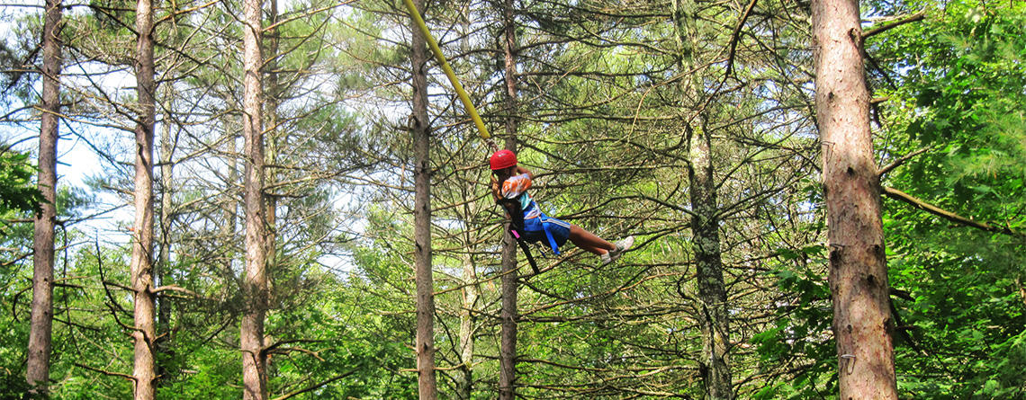 Teen camper doing the Ropes Course at Wildwood