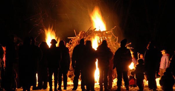 People gathering around the bonfire