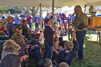Wildlife rehabilitator Tom Ricardi with a Barred Owl at Laughing Brook's Nature Festival