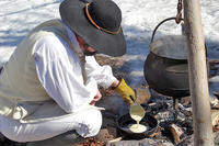 Cooking pancakes over a fire