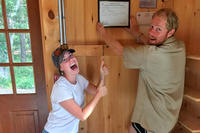 Hanging up the preschool's state license in the classroom