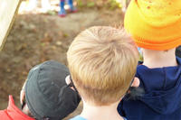 Three children watching trail volunteers working at Felix Neck Wildlife Sanctuary