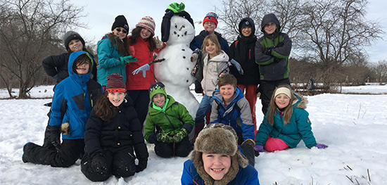 Posing with a snowman during February Vacation Days