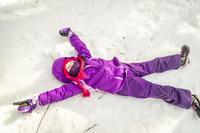Girl making a snow angel at a Mass Audubon wildlife sanctuary © Phil Doyle