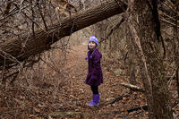 Girl exploring a wooded thicket in winter © Paul Blankman