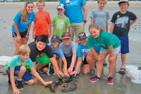 Joppa Flats campers on the beach with a huge lobster
