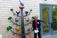 Local sculptor Alfred Glover next to his donated creation at Long Pasture's new Discovery Center