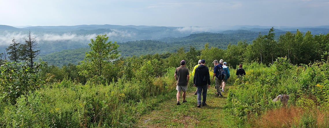 Group of adults at summit of Old Road Trail at Old Baldy Wildlife Sanctuary